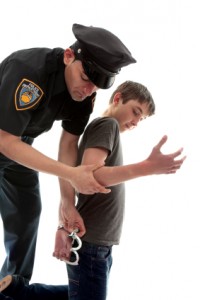 Policeman arresting juvenile criminal